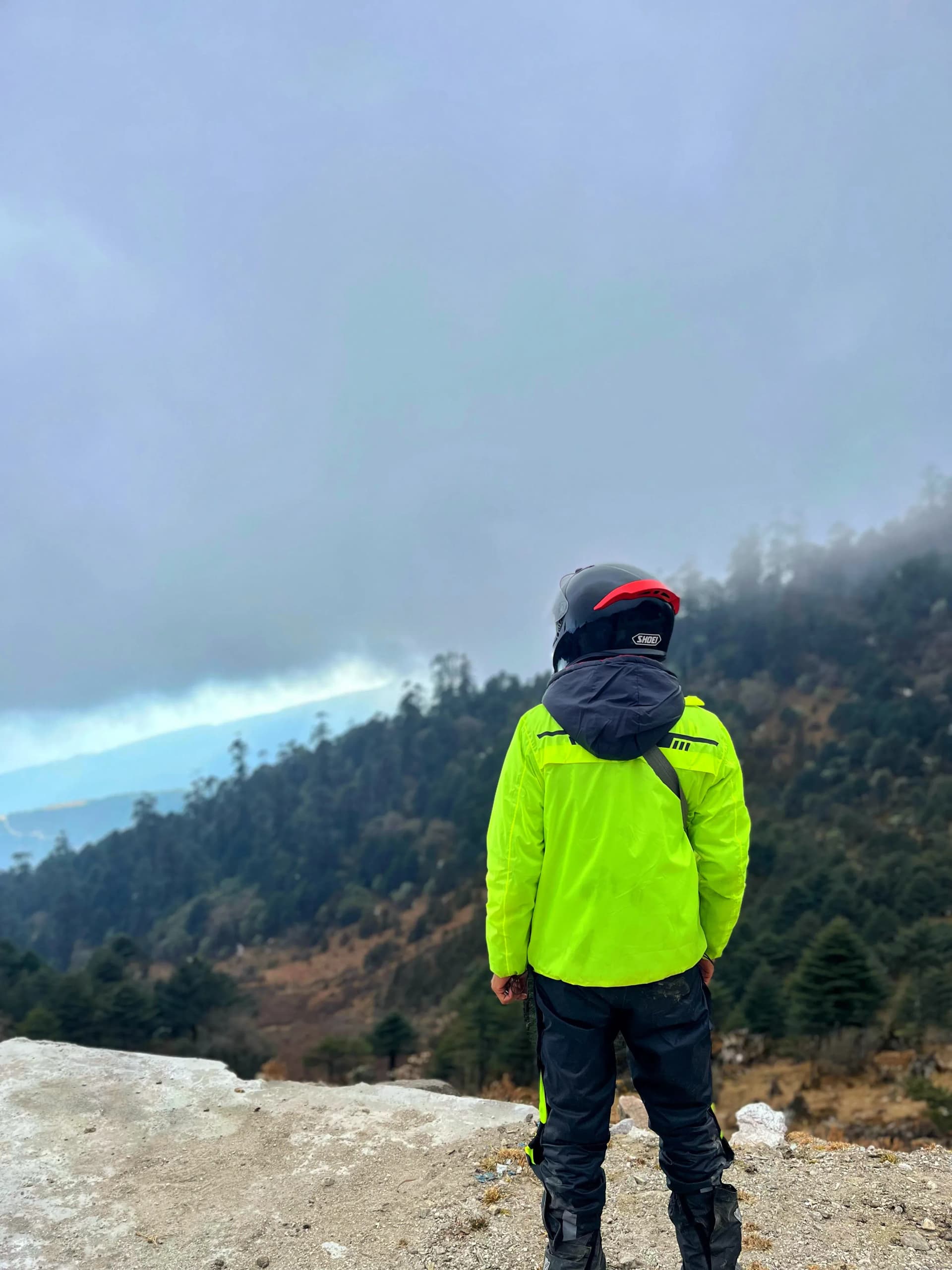 Masum Hussain riding through misty mountains
